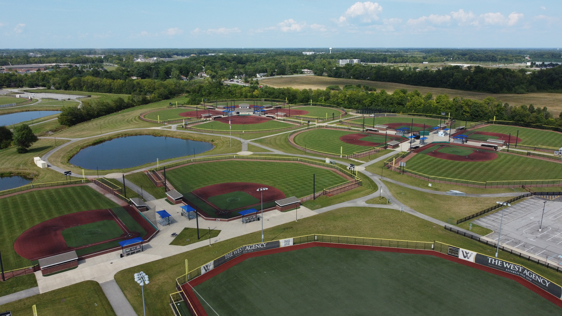 Night aerial view of the illuminated athletic fields at Droplight Grand Park